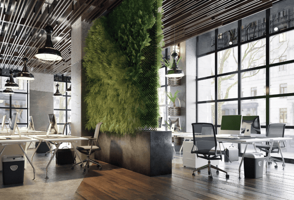 Modern ergonomic office design featuring height-adjustable standing desks, ergonomic chairs, and a green living wall to enhance employee well-being and productivity, with ample natural light from large windows.
